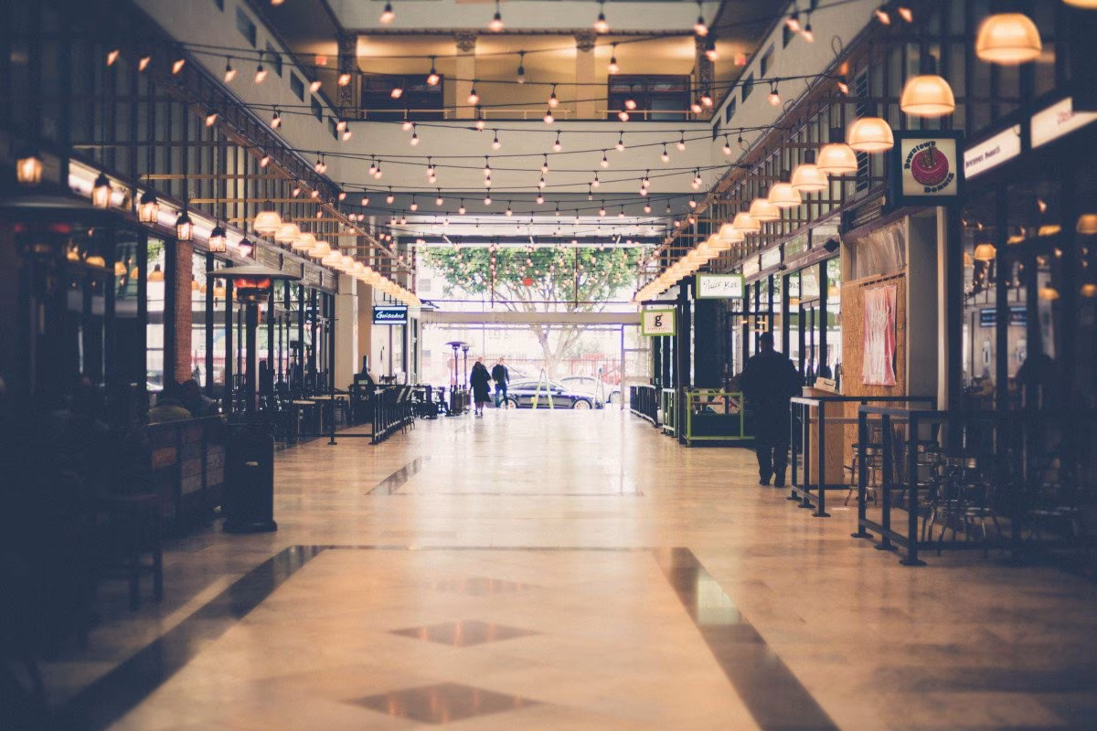 Interior of a shopping arcade with people and decorative lights from Stockmark.it