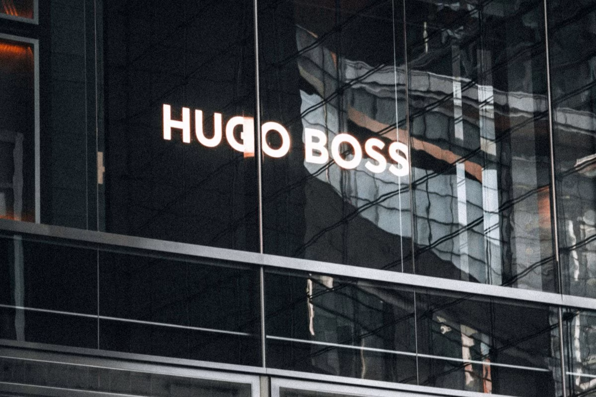 Hugo Boss logo illuminated on a modern building facade, reflecting Frasers Group's acquisition. from Stockmark.it